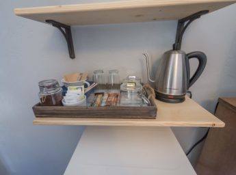 Coffee perculator and snacks on shelf